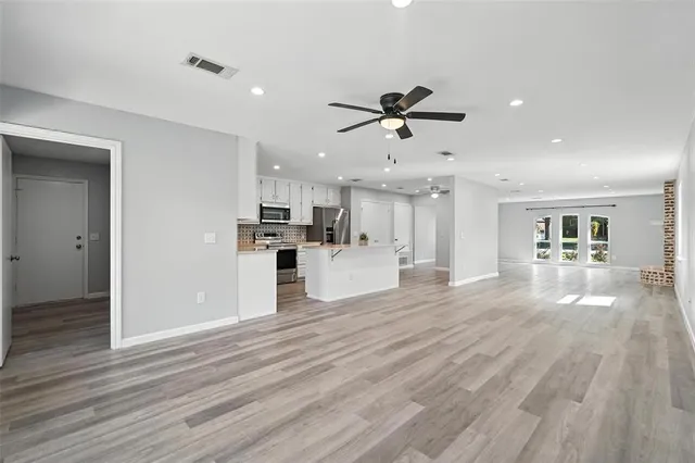 a view of a kitchen with a sink and a refrigerator