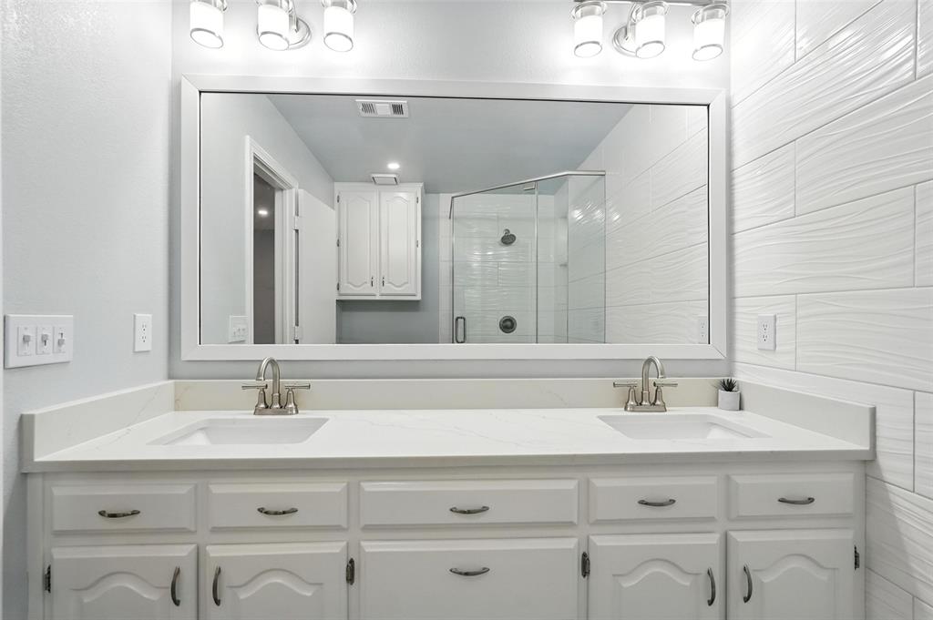 1402 Country Lane Allen, TX 75002 - Photo 22 of 39 Bathroom with double vanity and a shower stall