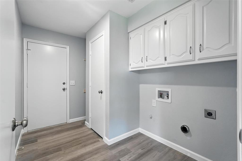 1402 Country Lane Allen, TX 75002 - Photo 23 of 39 Laundry room with light wood-style floors, hookup for a washing machine, gas dryer hookup, hookup for an electric dryer, and cabinet space