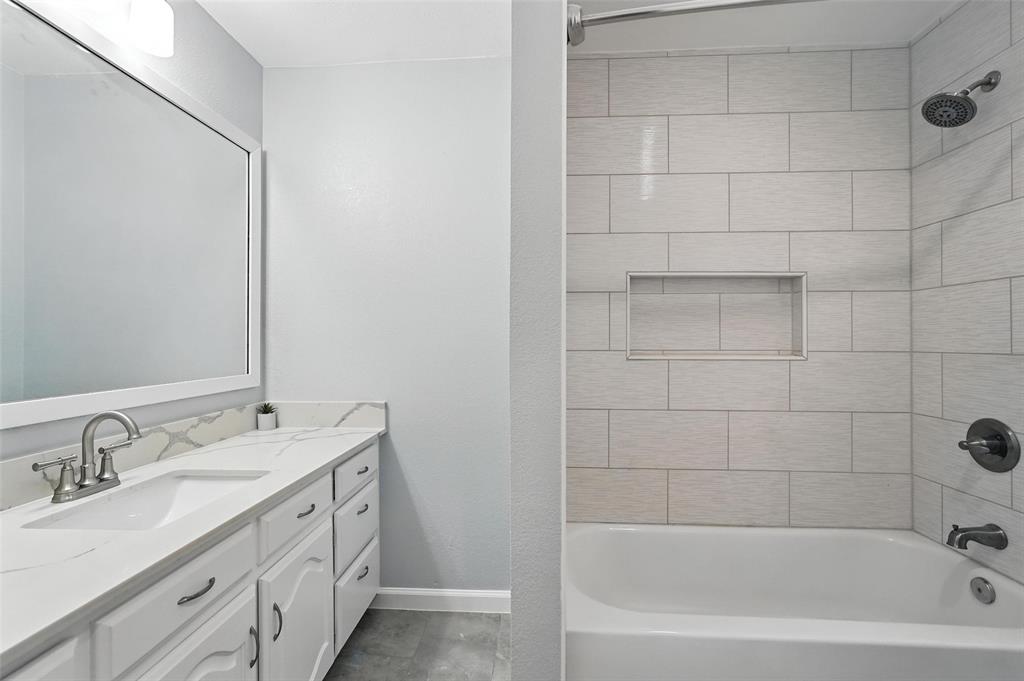 1402 Country Lane Allen, TX 75002 - Photo 24 of 39 Full bathroom with vanity and bathing tub / shower combination