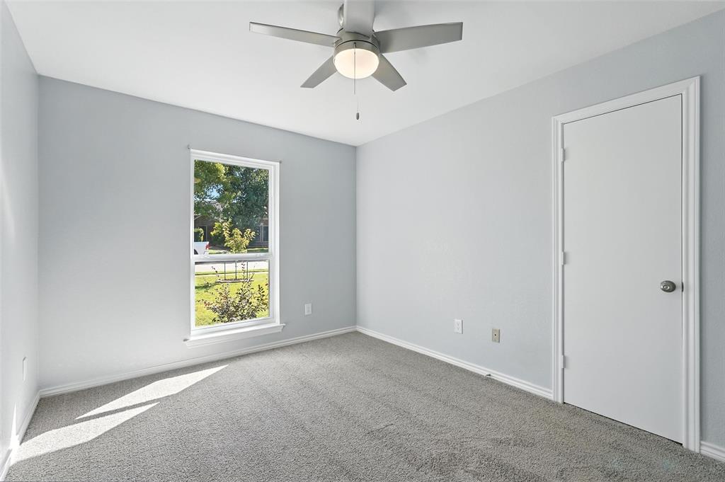 1402 Country Lane Allen, TX 75002 - Photo 27 of 39 Carpeted spare room featuring a ceiling fan and baseboards