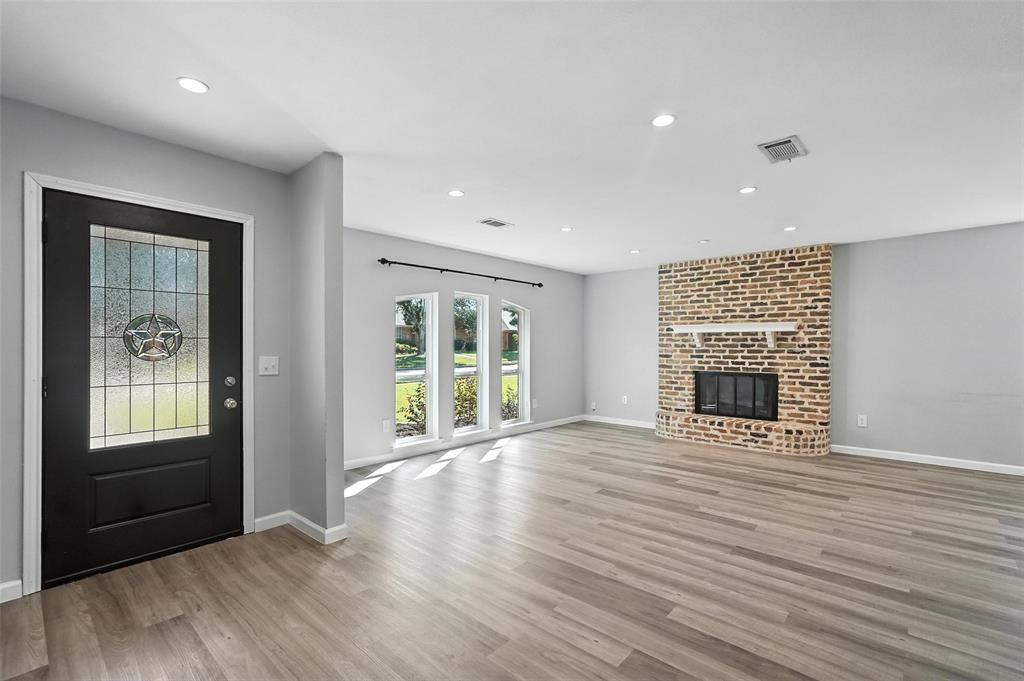 1402 Country Lane Allen, TX 75002 - Photo 5 of 39 Entryway featuring light wood finished floors, recessed lighting, and a fireplace