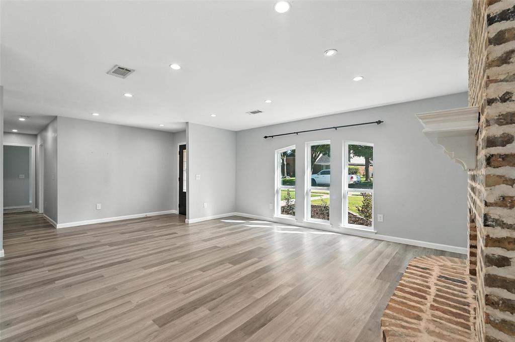 1402 Country Lane Allen, TX 75002 - Photo 6 of 39 Unfurnished living room featuring recessed lighting and light wood-style floors