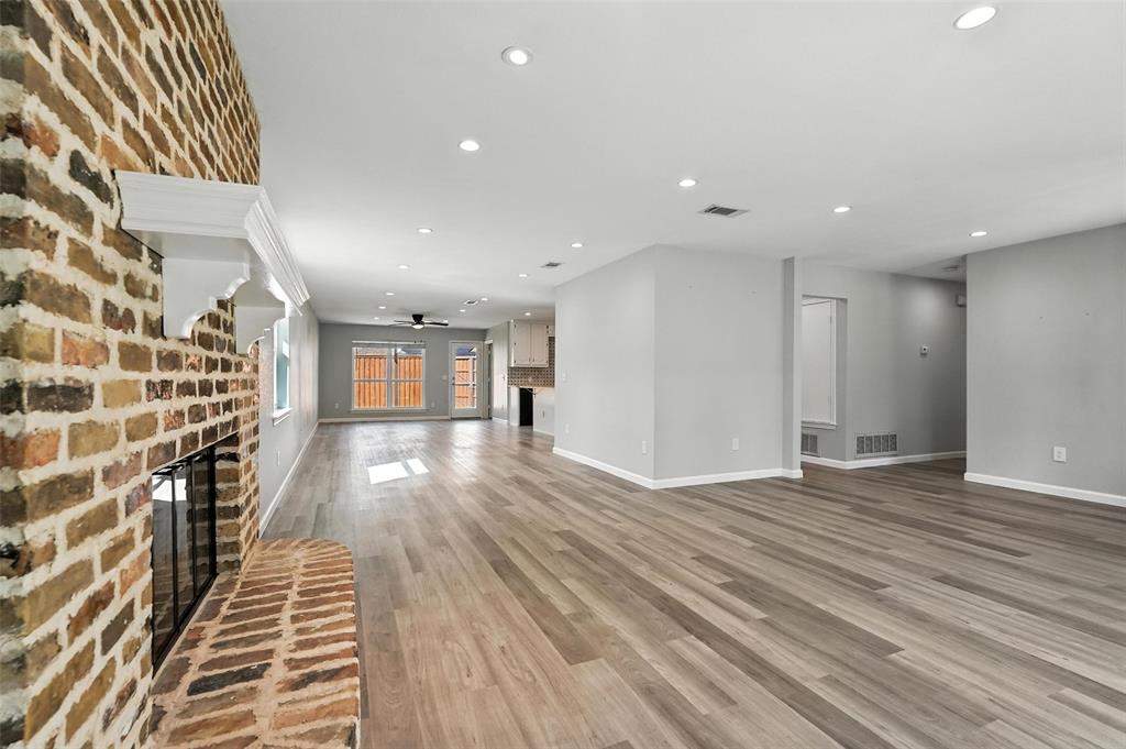 1402 Country Lane Allen, TX 75002 - Photo 8 of 39 Unfurnished living room featuring a fireplace, recessed lighting, light wood finished floors, and ceiling fan