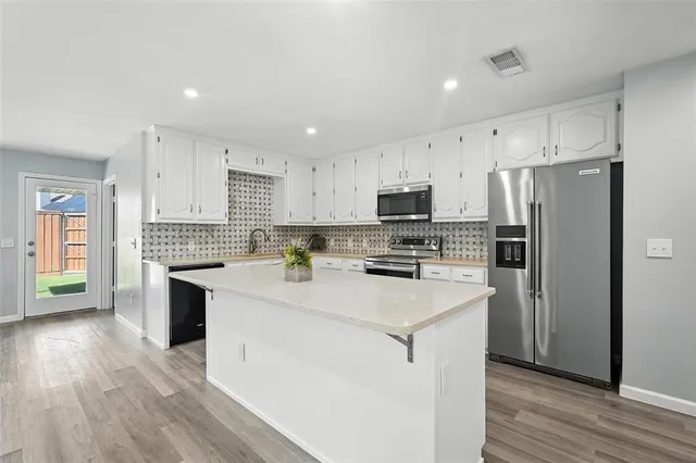 a view of a kitchen with wooden floor and a kitchen