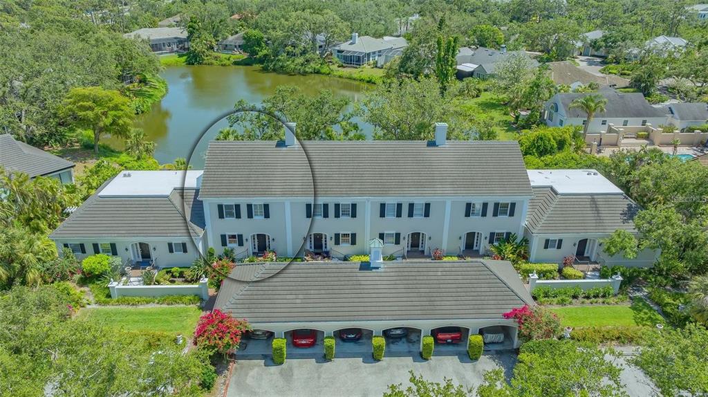 an aerial view of a house with swimming pool and garden