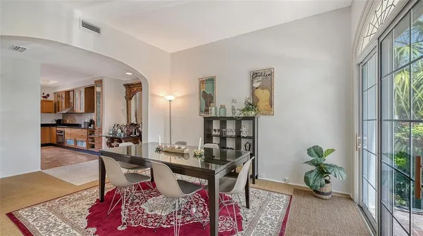 a living room with furniture windows and a potted plant