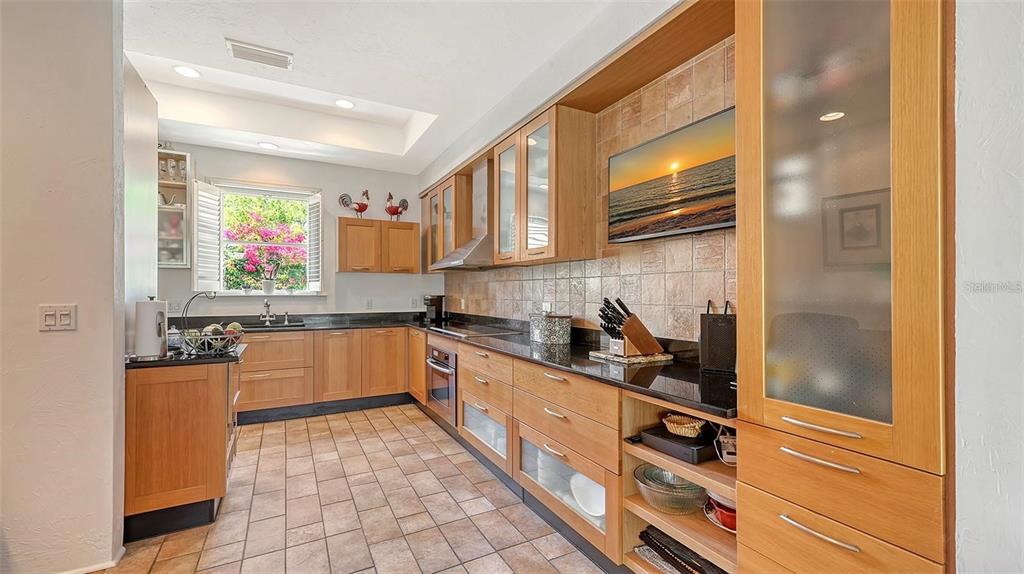 33 Bishopscourt Road, Unit 118 Osprey, FL 34229 - Photo 18 of 69 a kitchen with stainless steel appliances granite countertop a refrigerator and a stove