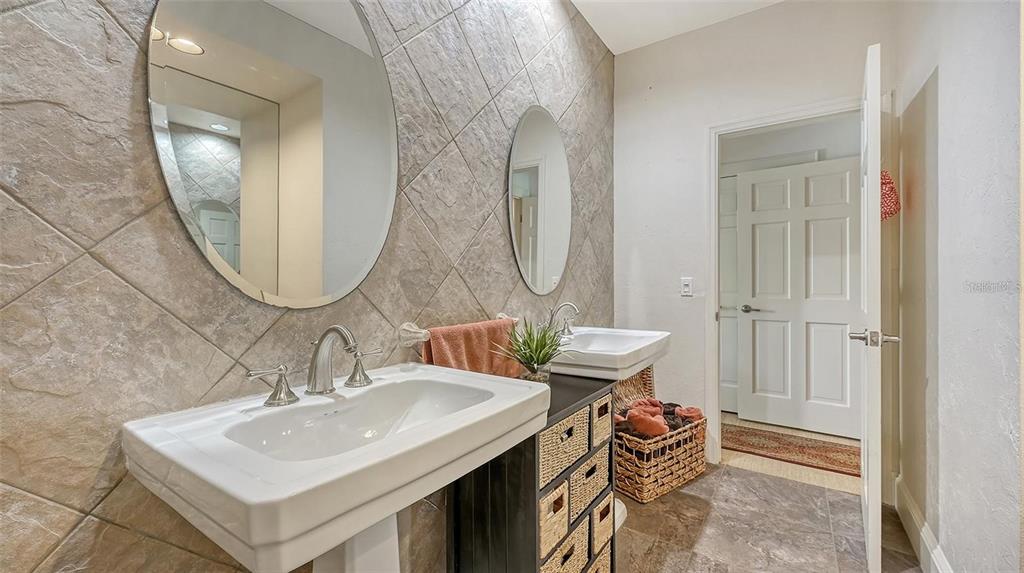 33 Bishopscourt Road, Unit 118 Osprey, FL 34229 - Photo 30 of 69 a bathroom with a sink and a mirror