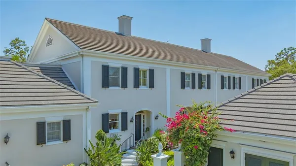 a front view of a house with plants