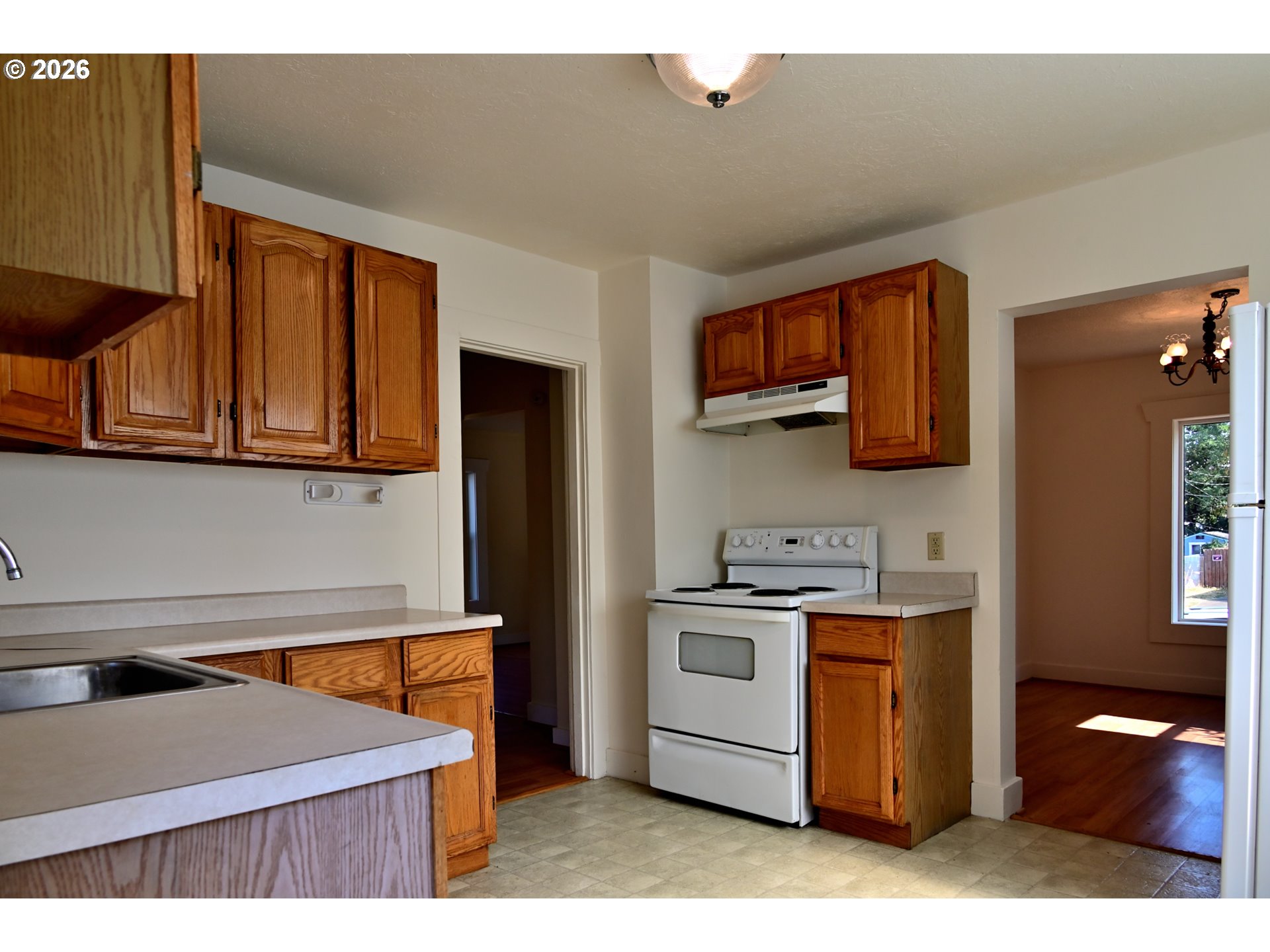 3407 Northeast 81st Avenue Portland, OR 97213 - Photo 5 of 11 a kitchen with stainless steel appliances granite countertop a sink stove and refrigerator