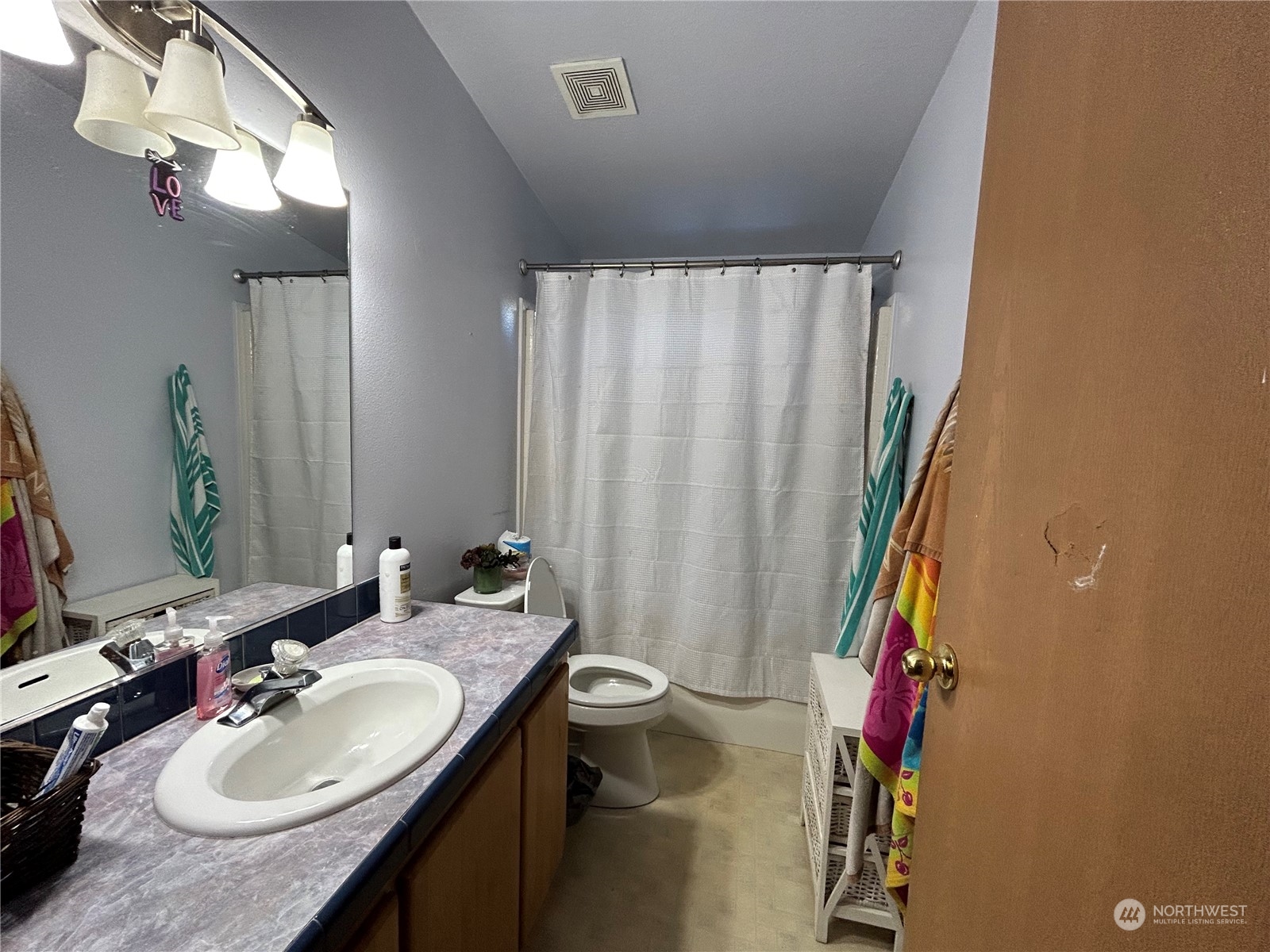 9342 Phillips Road Southeast Port Orchard, WA 98367 - Photo 11 of 12 a bathroom with a granite countertop sink and a mirror