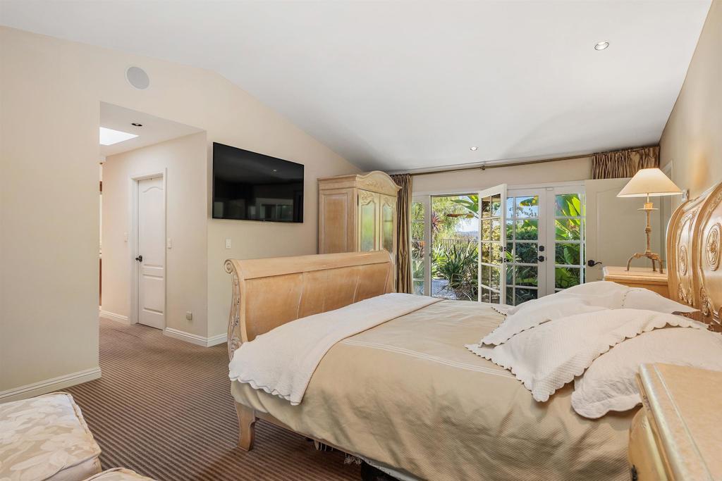 16346 Via Del Alba Rancho Santa Fe, CA 92067 - Photo 15 of 34 a bedroom with a bed and a flat screen tv
