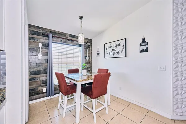 a room with lots of white furniture and wooden floor