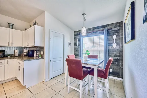 an outdoor view of the kitchen with seating area