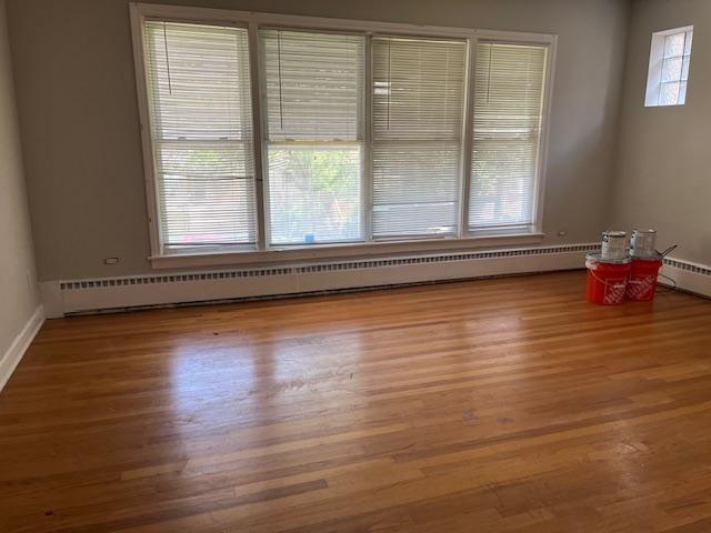 6100 South Kenneth Avenue, Unit 2 Chicago, IL 60629 - Photo 3 of 14 a view of an empty room with wooden floor and a window