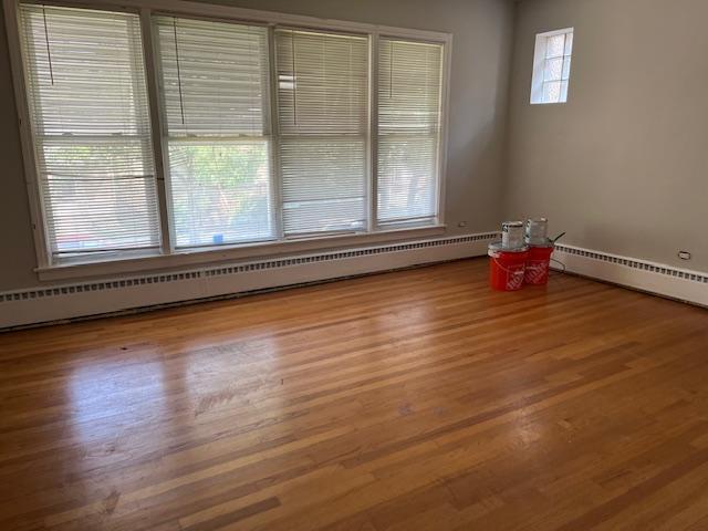 6100 South Kenneth Avenue, Unit 2 Chicago, IL 60629 - Photo 4 of 14 a view of an empty room with wooden floor and a window