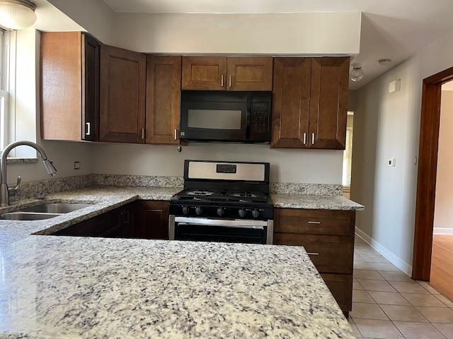6100 South Kenneth Avenue, Unit 2 Chicago, IL 60629 - Photo 8 of 14 a kitchen with granite countertop a stove and a sink