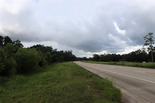 a view of a street with of trees in the background