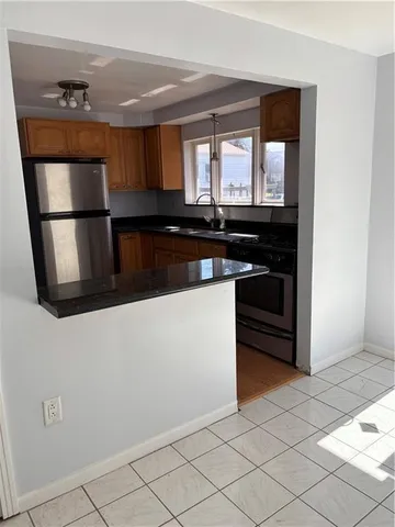 a kitchen with stainless steel appliances granite countertop a stove and a microwave