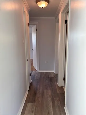 a view of a room with wooden floor