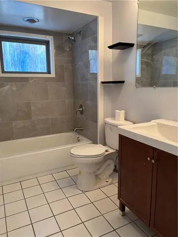 a bathroom with a sink a toilet and bathtub