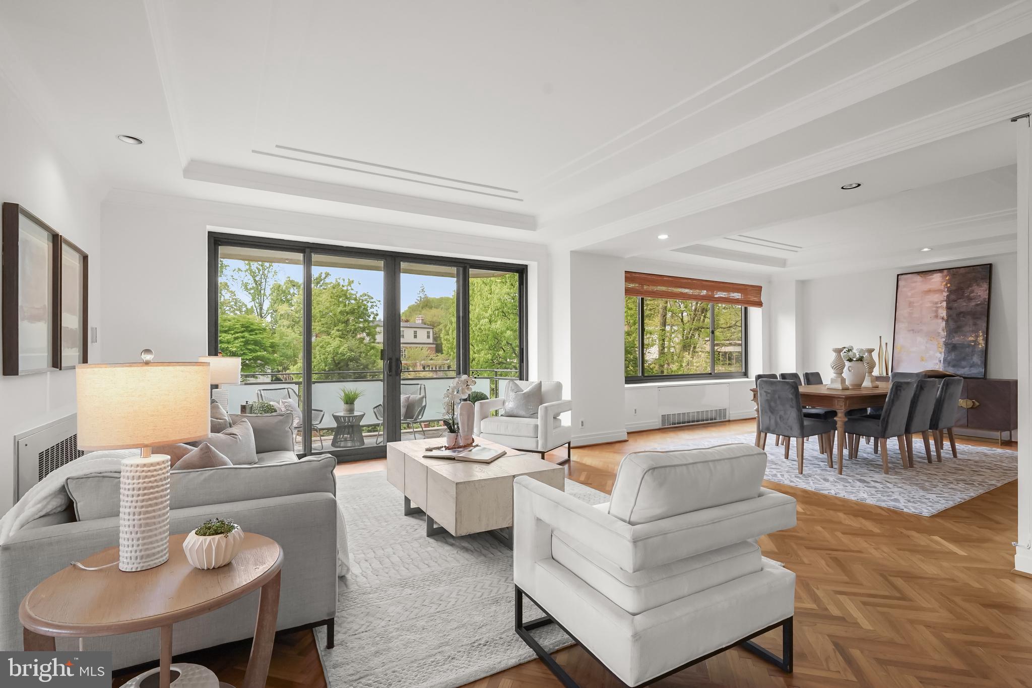 a living room with fireplace furniture and a large window
