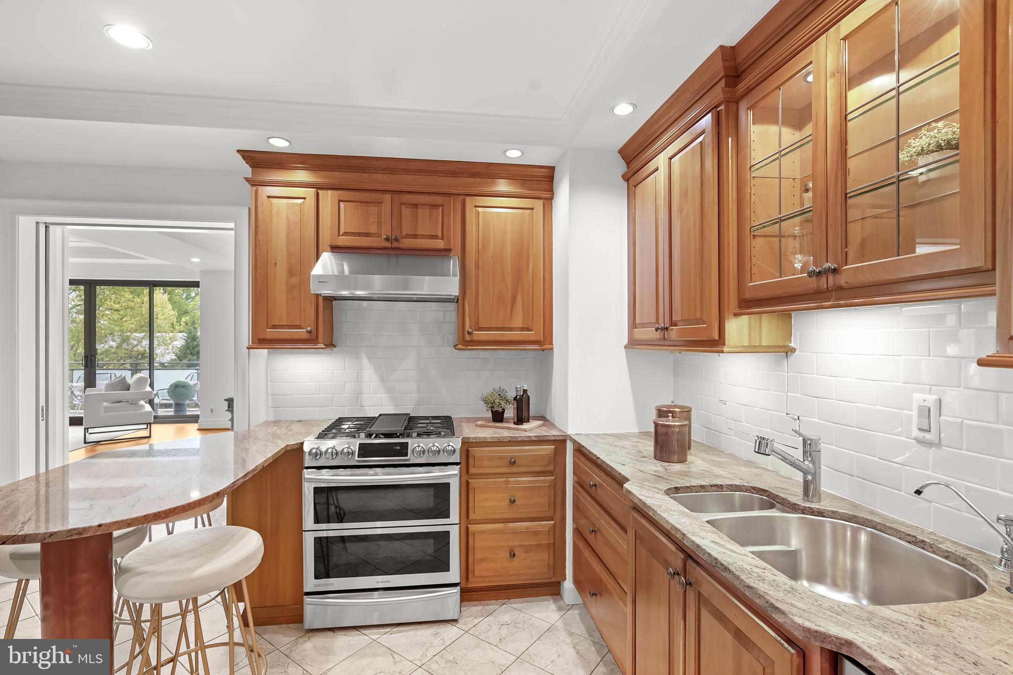 2700 Calvert Street Northwest, Unit 416 Washington, DC 20008 - Photo 11 of 33 a kitchen with stainless steel appliances a stove sink and cabinets