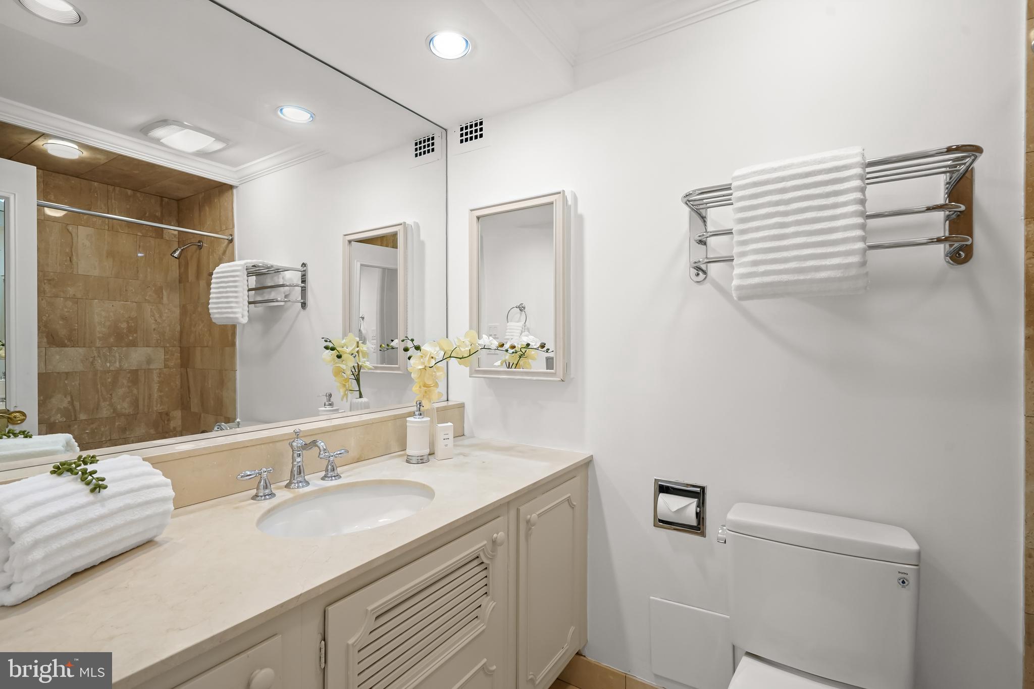 2700 Calvert Street Northwest, Unit 416 Washington, DC 20008 - Photo 19 of 33 a bathroom with a granite countertop sink a toilet and a mirror