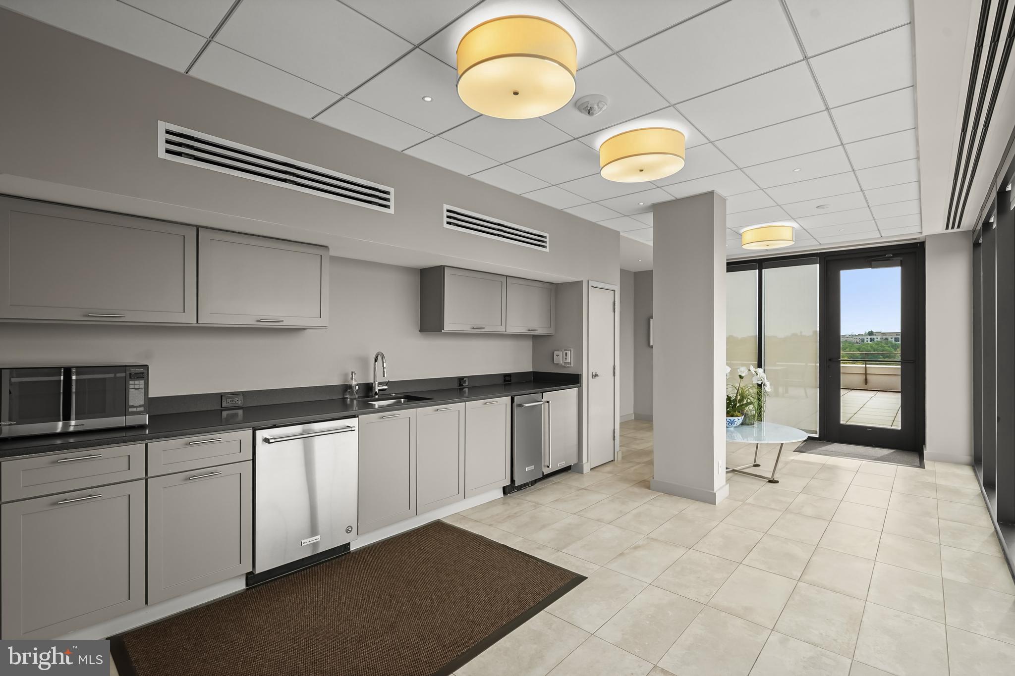 2700 Calvert Street Northwest, Unit 416 Washington, DC 20008 - Photo 28 of 33 a kitchen with stainless steel appliances granite countertop a sink a stove cabinets and a window
