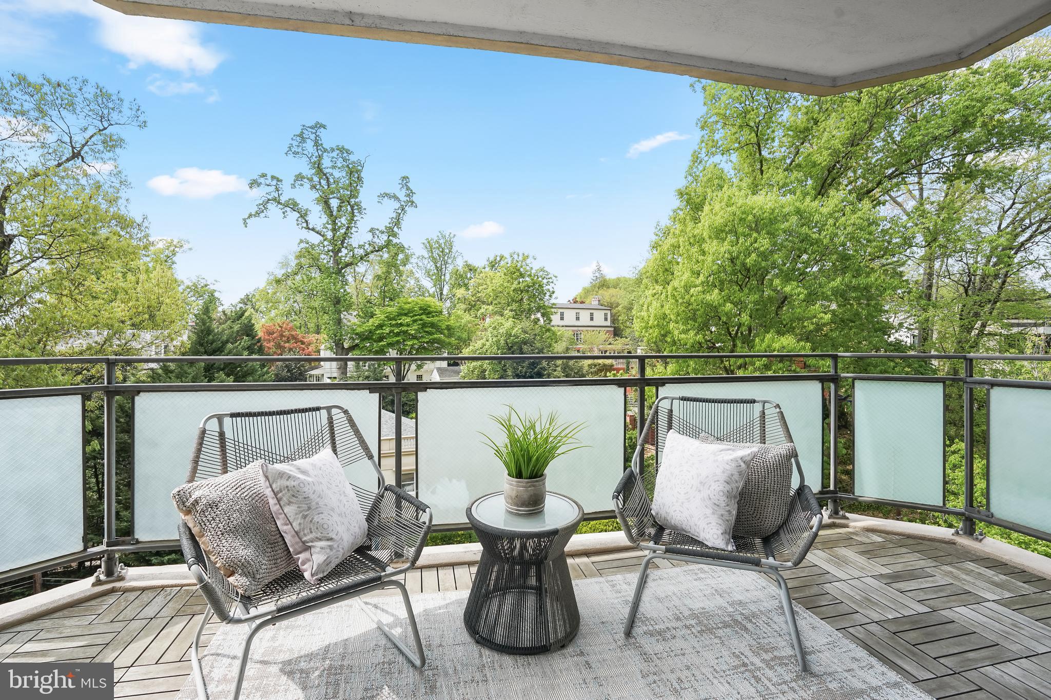 2700 Calvert Street Northwest, Unit 416 Washington, DC 20008 - Photo 7 of 33 a balcony with couple of chairs and a potted plant
