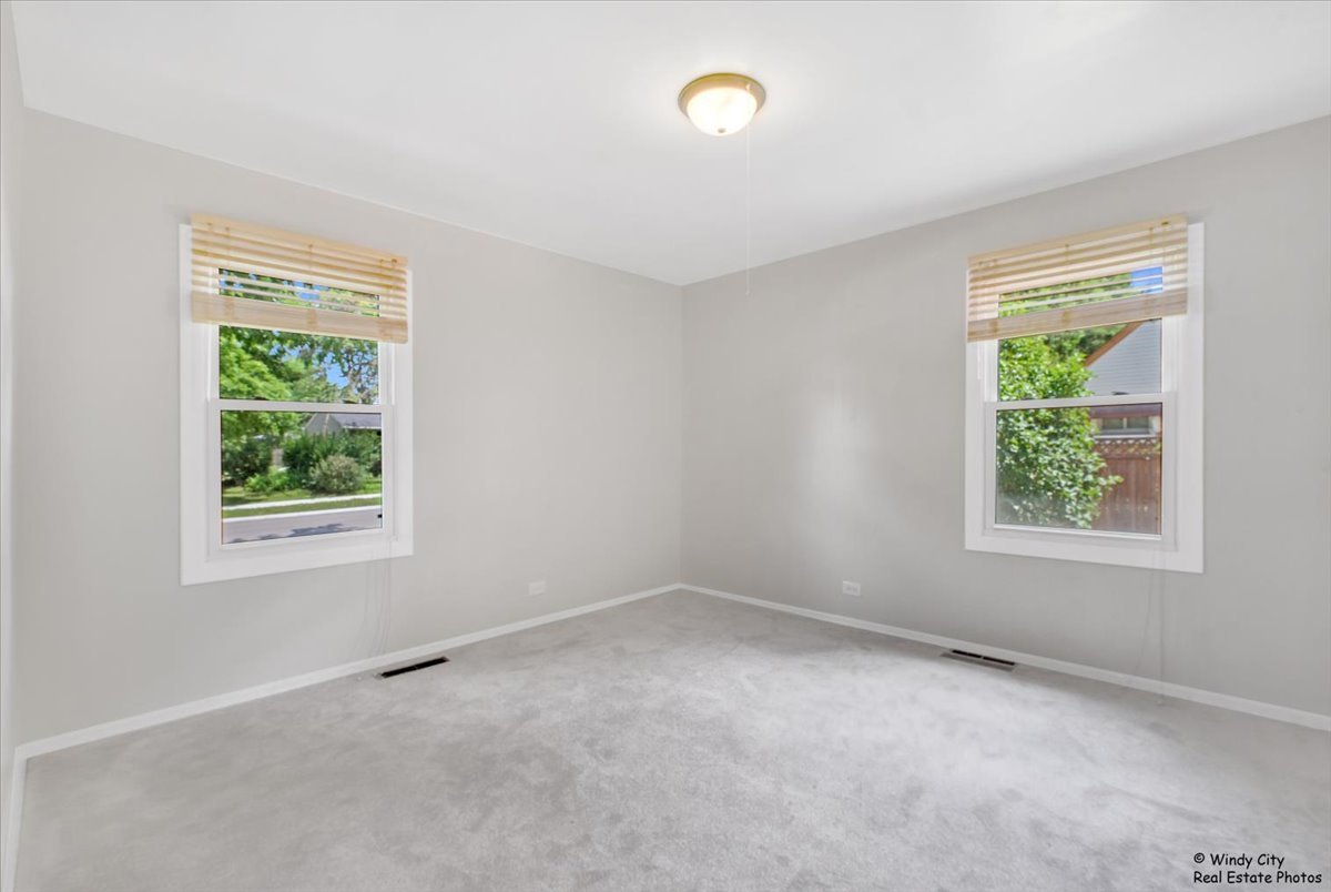 383 Raupp Boulevard Buffalo Grove, IL 60089 - Photo 12 of 40 an empty room with windows
