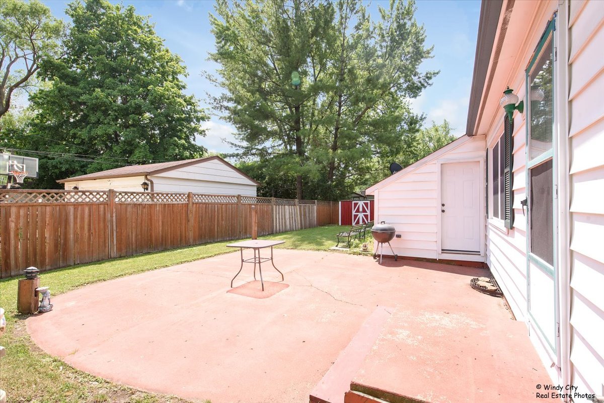 383 Raupp Boulevard Buffalo Grove, IL 60089 - Photo 29 of 40 a view of backyard with a slide and a large tree