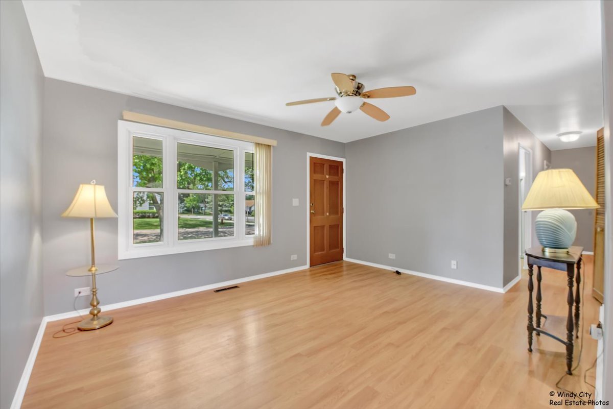 383 Raupp Boulevard Buffalo Grove, IL 60089 - Photo 3 of 40 a view of an empty room with a window and a chandelier