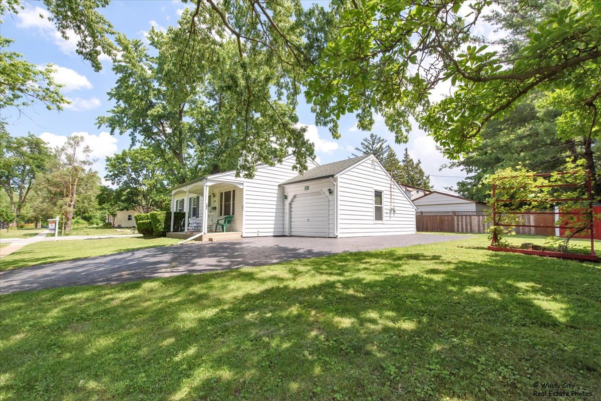 383 Raupp Boulevard Buffalo Grove, IL 60089 - Photo 39 of 40 a view of a yard with a house and a large tree