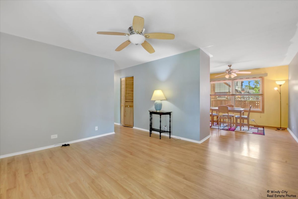 383 Raupp Boulevard Buffalo Grove, IL 60089 - Photo 5 of 40 a view of an empty room with wooden floor and a window