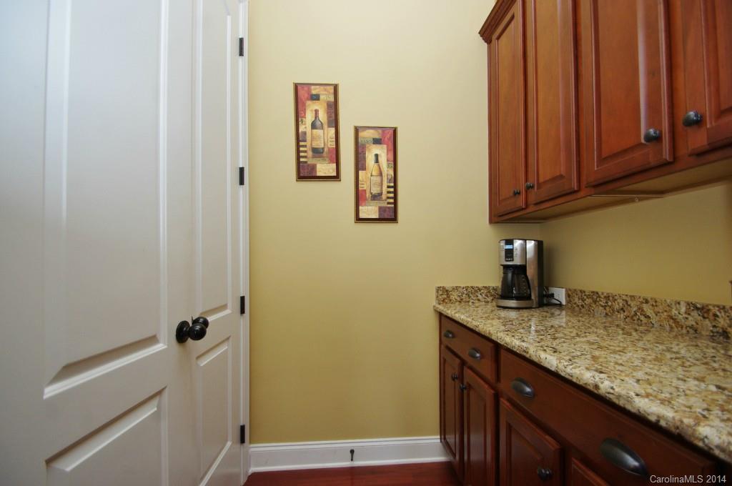 1010 Hamil Ridge Drive, Unit 929 Waxhaw, NC 28173 - Photo 11 of 24 a bathroom with a granite countertop sink and a mirror