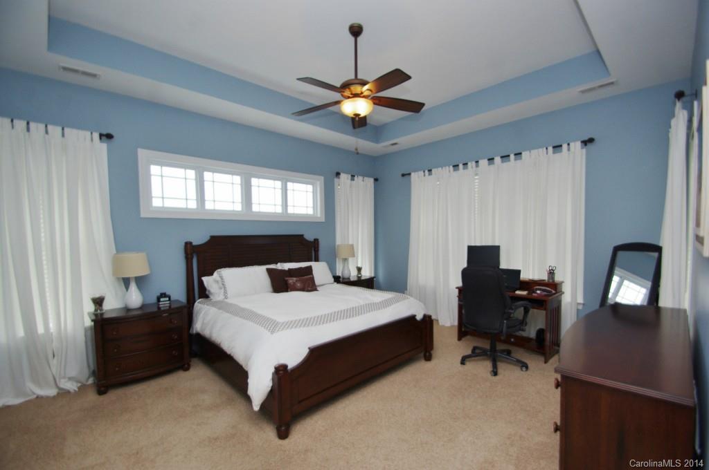 1010 Hamil Ridge Drive, Unit 929 Waxhaw, NC 28173 - Photo 13 of 24 a bedroom with a bed desk and a window