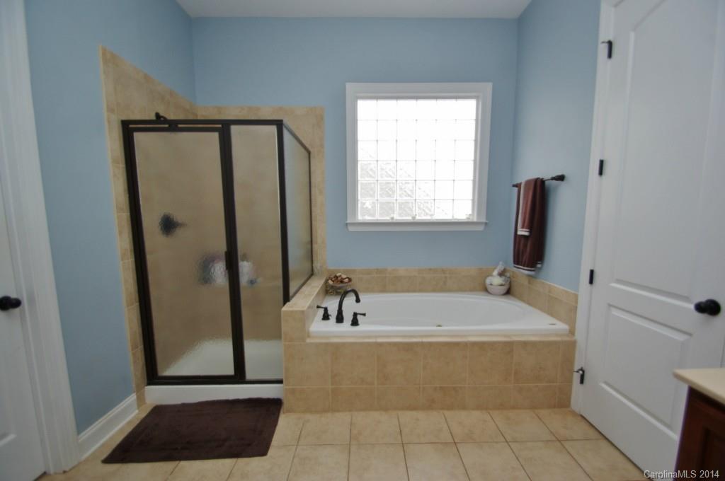 1010 Hamil Ridge Drive, Unit 929 Waxhaw, NC 28173 - Photo 15 of 24 a bathroom with a tub a sink and a window