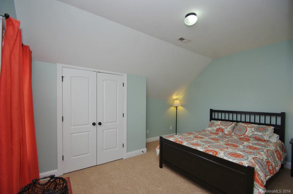 1010 Hamil Ridge Drive, Unit 929 Waxhaw, NC 28173 - Photo 20 of 24 a bed sitting in a bedroom next to a cabinet
