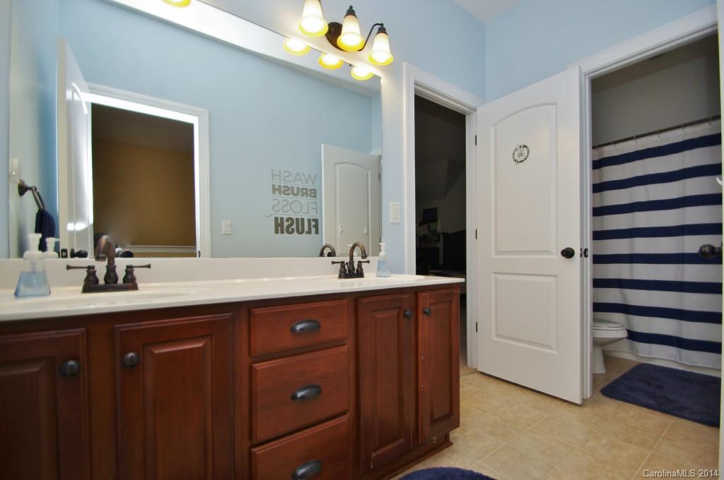1010 Hamil Ridge Drive, Unit 929 Waxhaw, NC 28173 - Photo 21 of 24 a bathroom with a double vanity sink and a mirror