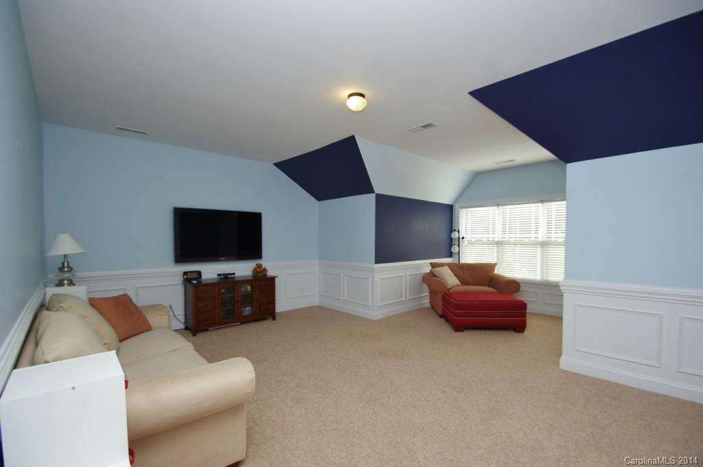 1010 Hamil Ridge Drive, Unit 929 Waxhaw, NC 28173 - Photo 22 of 24 a living room with furniture and a flat screen tv