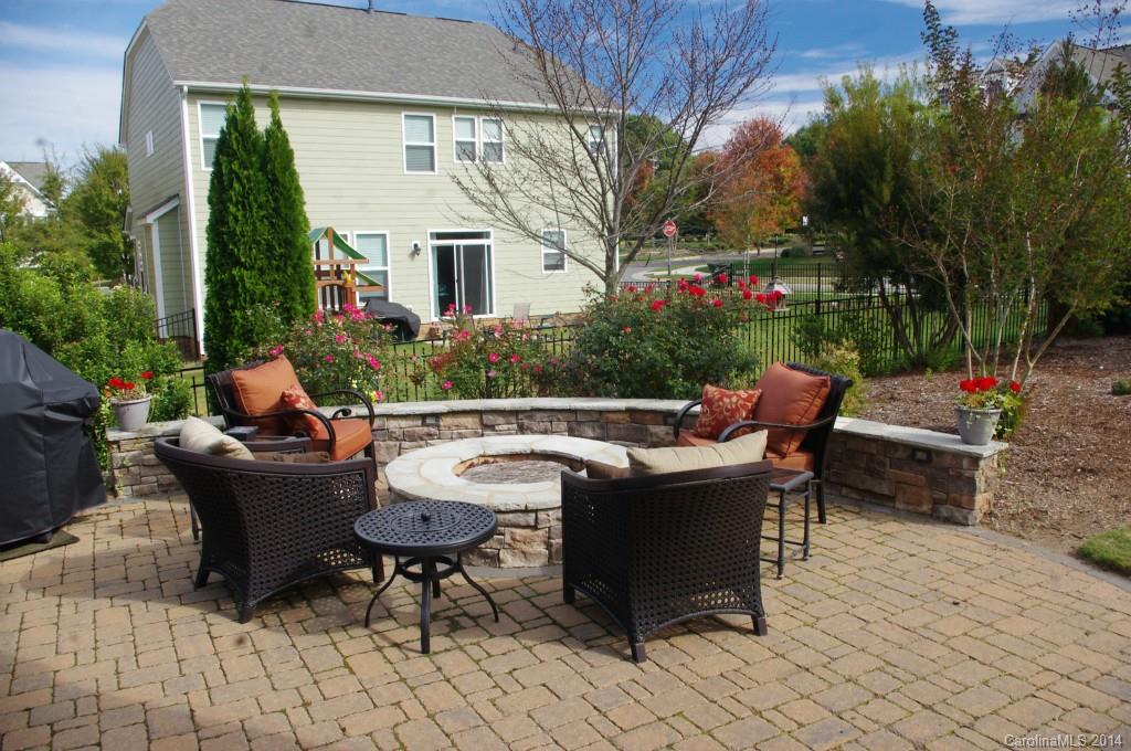 1010 Hamil Ridge Drive, Unit 929 Waxhaw, NC 28173 - Photo 4 of 24 a view of a patio with couches table and chairs and potted plants
