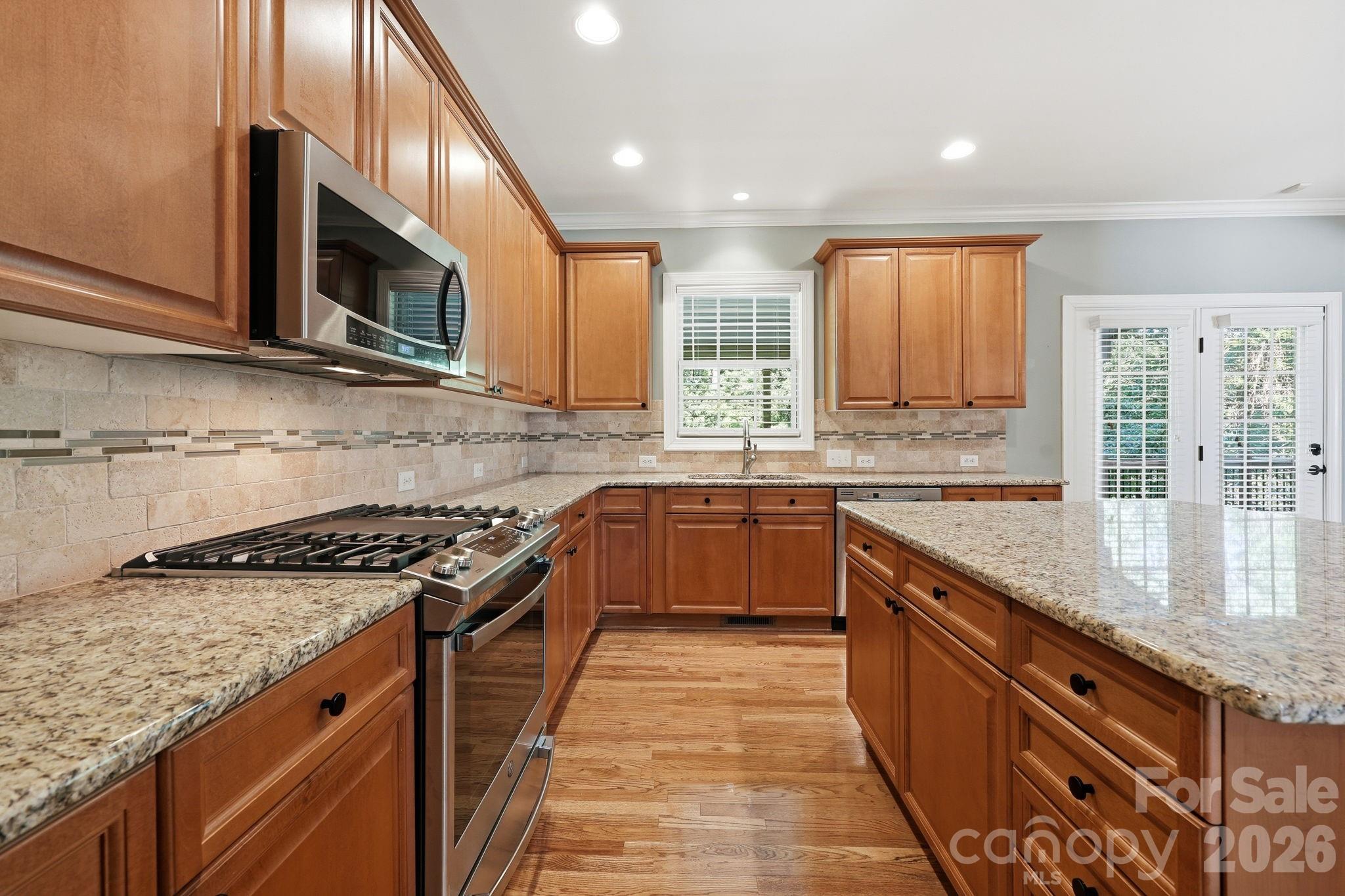 3308 Grandeur Road Charlotte, NC 28269 - Photo 14 of 45 a kitchen with stainless steel appliances granite countertop a stove a sink and a microwave