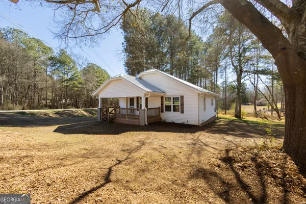 a front view of a house with yard covered in snow