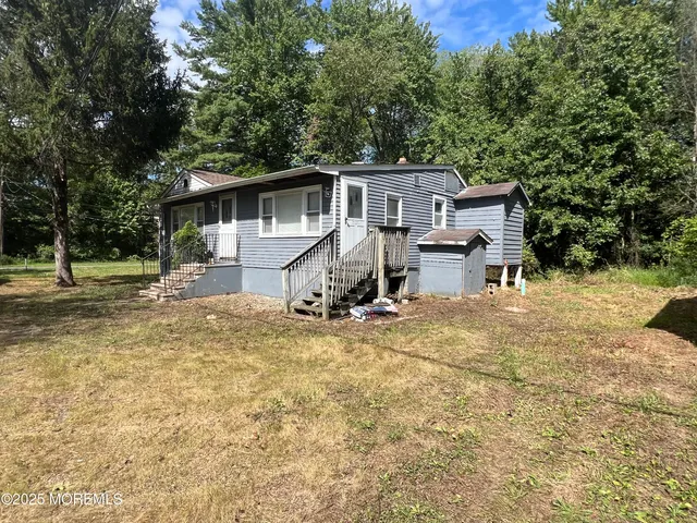 a view of a house with backyard and sitting area