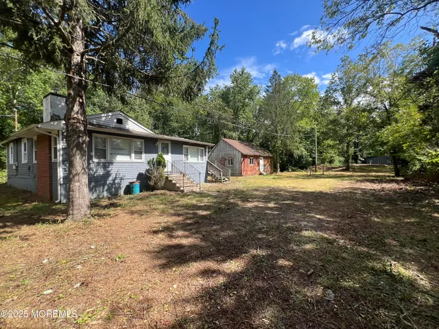 a view of a field with trees in the background