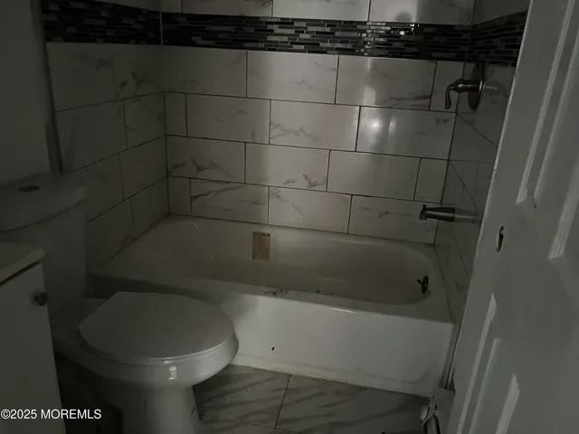 a bathroom with a toilet and a sink