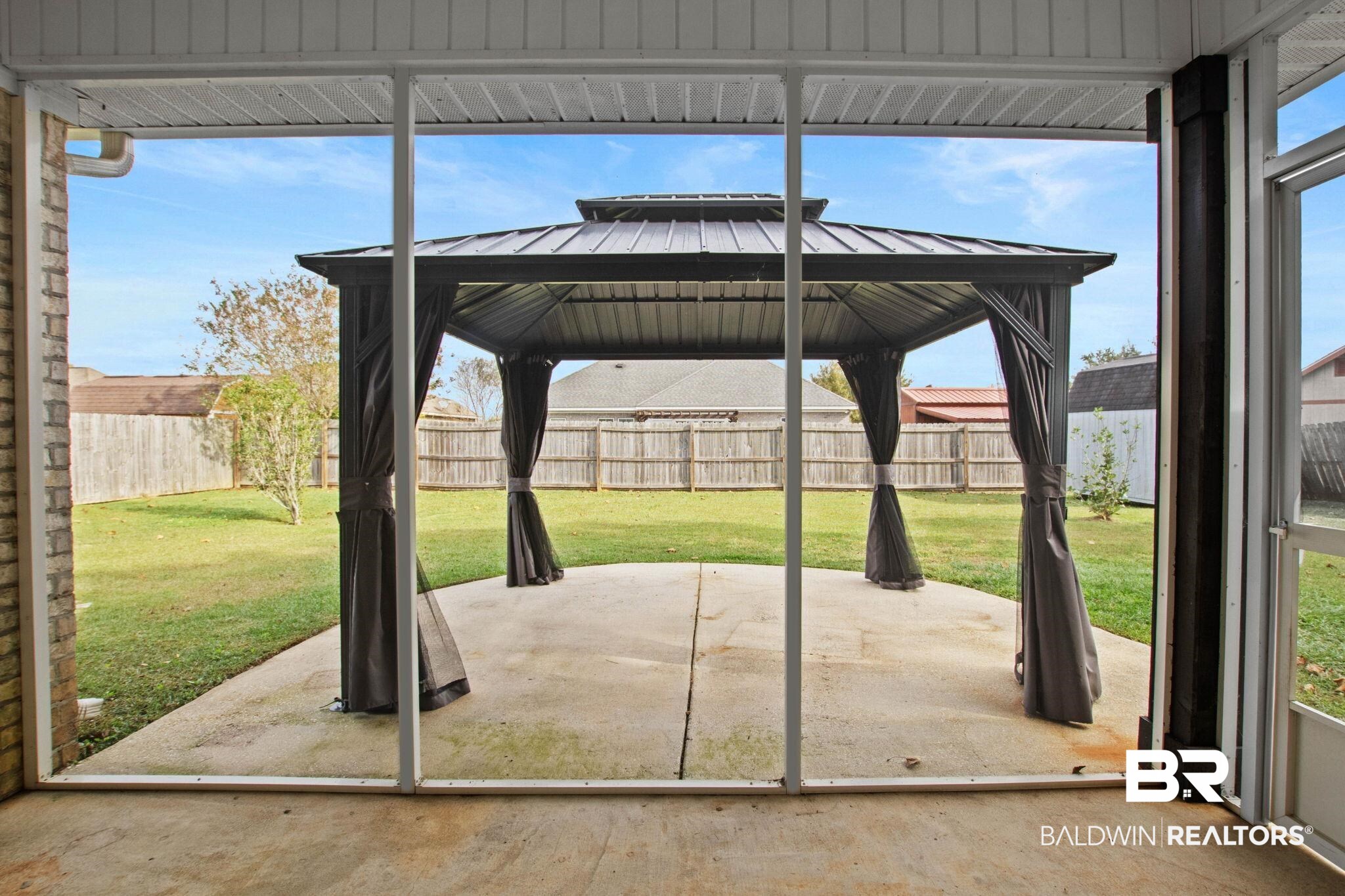 17376 Bankhead Boulevard Fairhope, AL 36532 - Photo 69 of 73 Fenced backyard featuring a gazebo and a patio area
