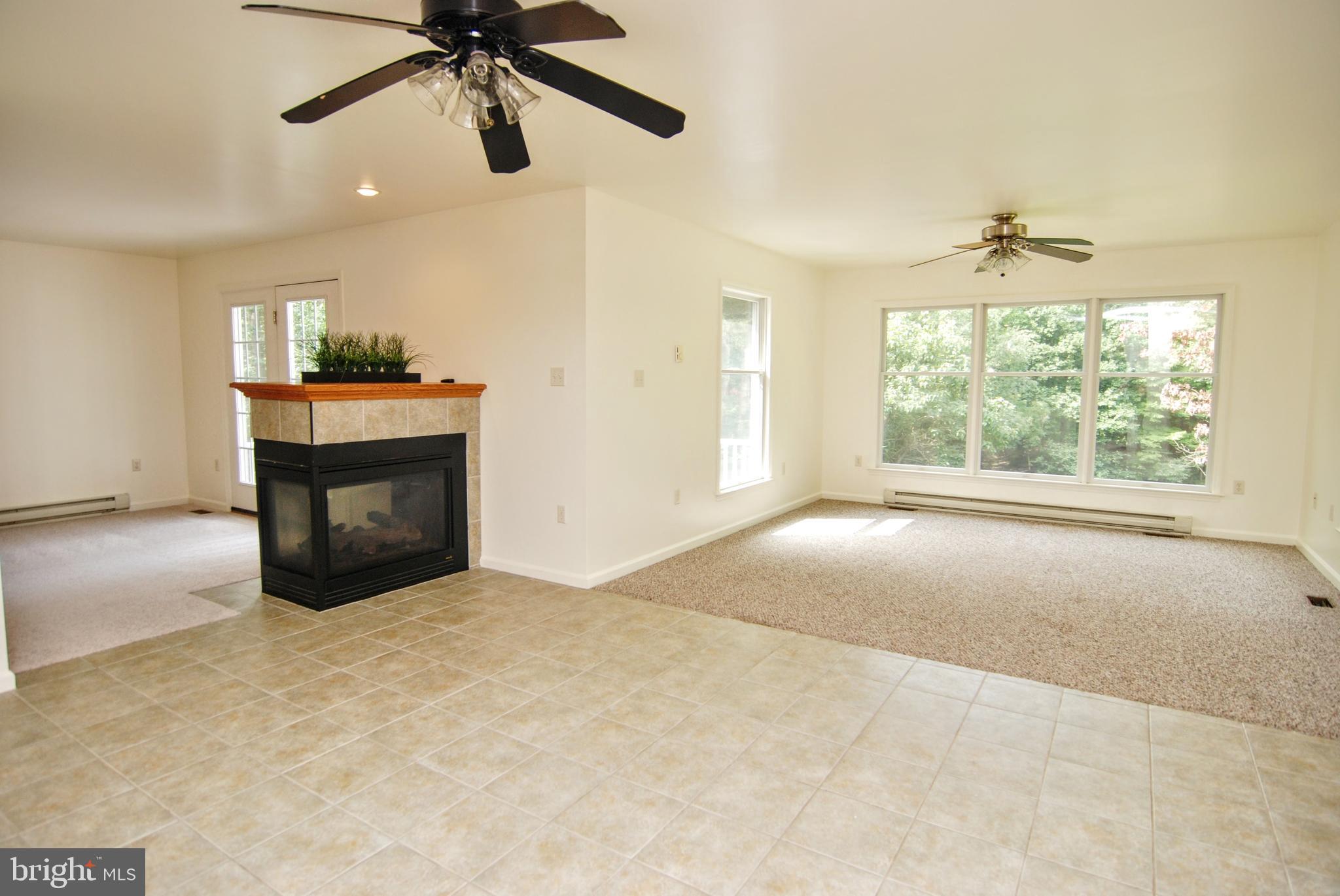 5902 Moser Road Boonsboro, MD 21713 - Photo 9 of 37 The 3 sided gas fireplace will is a focal point.